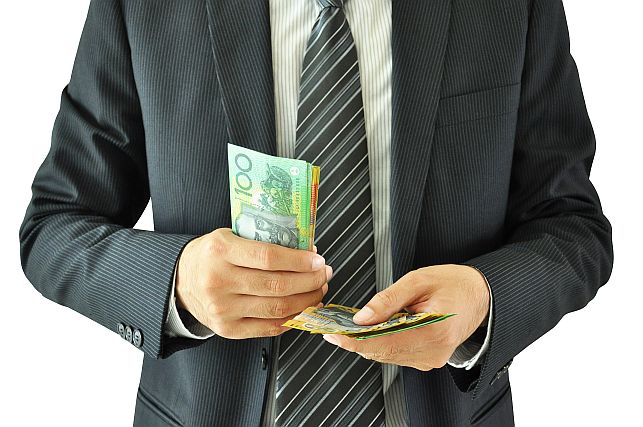 Businessman holding money - Australian dollars